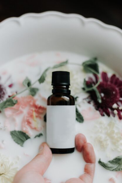 Picture of a bottle of oil in front of milky water